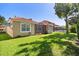 A spacious backyard features green grass, an irrigation system, and a screened-in patio at 11316 Rapallo Ln, Windermere, FL 34786