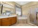 This is a bathroom with double sinks, a corner tub, and a separate glass shower at 11316 Rapallo Ln, Windermere, FL 34786