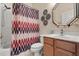 Bathroom featuring a shower-tub combo, a vanity with a mirror, and colorful accents at 11316 Rapallo Ln, Windermere, FL 34786