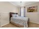 Inviting bedroom with a comfortable bed, window with curtains, and carpeted floor at 11316 Rapallo Ln, Windermere, FL 34786