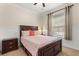 Cozy bedroom with a comfortable bed, bedside table, and natural light from the window at 11316 Rapallo Ln, Windermere, FL 34786