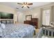 This bright bedroom features a ceiling fan, large window, and a television at 11316 Rapallo Ln, Windermere, FL 34786