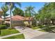 Inviting single-story home with a tile roof, a brick driveway, and manicured landscaping at 11316 Rapallo Ln, Windermere, FL 34786