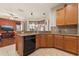 Bright kitchen featuring granite countertops, wood cabinets, and a view to the breakfast nook and living area at 11316 Rapallo Ln, Windermere, FL 34786