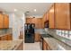 Spacious kitchen with granite countertops, stainless steel appliances, wood cabinets, and tile flooring at 11316 Rapallo Ln, Windermere, FL 34786