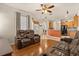 Open living area with hardwood floors flowing into a kitchen with stainless steel appliances at 11316 Rapallo Ln, Windermere, FL 34786