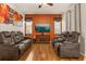 Cozy living room with theater seating, warm wood floors, and bright accent wall at 11316 Rapallo Ln, Windermere, FL 34786