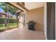 This screened patio offers a grill and a view to the landscaped backyard at 11316 Rapallo Ln, Windermere, FL 34786