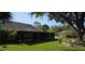 Lush backyard features a screened-in lanai and mature trees providing shade at 11818 Sophia Ln, Orlando, FL 32821