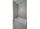 Bathroom featuring a tiled bath and shower combo with chrome fixtures at 11818 Sophia Ln, Orlando, FL 32821