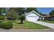Inviting single-story home boasting a lovely lawn and a convenient two-car attached garage at 11818 Sophia Ln, Orlando, FL 32821