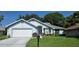 Charming single-story home features a well-manicured lawn and attached two-car garage at 11818 Sophia Ln, Orlando, FL 32821