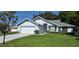 Well-maintained single-story home features lush green lawn and two-car attached garage at 11818 Sophia Ln, Orlando, FL 32821