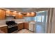 Well-lit kitchen features sleek black appliances, countertops and ample cabinet space at 11818 Sophia Ln, Orlando, FL 32821