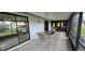 Spacious screened-in lanai with a table and chairs overlooking a peaceful backyard at 11818 Sophia Ln, Orlando, FL 32821