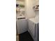 Well-organized laundry room with a modern washer, dryer, and shelving at 11818 Sophia Ln, Orlando, FL 32821