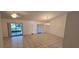 Spacious living room with tile flooring, vaulted ceiling, and sliding glass doors to the lanai at 11818 Sophia Ln, Orlando, FL 32821