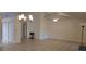 Open-concept living room features tile flooring, vaulted ceilings and neutral color palette at 11818 Sophia Ln, Orlando, FL 32821