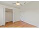 A bright bedroom featuring wood floors, a closet, and a ceiling fan at 1254 Shelter Rock Rd, Orlando, FL 32835