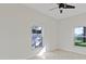 Bright bedroom with two large windows, neutral walls, and tile floors at 1254 Shelter Rock Rd, Orlando, FL 32835