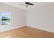 Bedroom with wood floors and natural light from the bright window at 1254 Shelter Rock Rd, Orlando, FL 32835