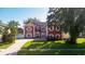 Beautiful two-story home with brick paved driveway, lush lawn, and manicured landscaping at 1254 Shelter Rock Rd, Orlando, FL 32835
