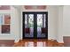 Spacious foyer with tile floors and a decorative wrought iron door at 1254 Shelter Rock Rd, Orlando, FL 32835
