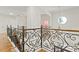 Upstairs hallway features wrought iron railings, hardwood floors and an abundance of natural light at 1254 Shelter Rock Rd, Orlando, FL 32835