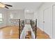Upstairs hallway featuring wrought iron railings, light hardwood floors, and natural light at 1254 Shelter Rock Rd, Orlando, FL 32835