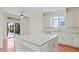 Eat-in kitchen features a large island, tiled backsplash, stainless steel appliances, and sliding glass doors at 1254 Shelter Rock Rd, Orlando, FL 32835