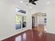 Bright living room with large windows, dark wood floors, and an arched doorway at 1254 Shelter Rock Rd, Orlando, FL 32835