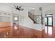 Open-concept living room with hardwood floors, adjacent to kitchen, and decorative staircase at 1254 Shelter Rock Rd, Orlando, FL 32835