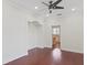 Spacious living room featuring crown moulding, a ceiling fan, and rich wood floors at 1254 Shelter Rock Rd, Orlando, FL 32835