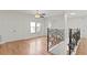 Open loft area featuring wood floors, a ceiling fan, and decorative wrought iron railing at 1254 Shelter Rock Rd, Orlando, FL 32835