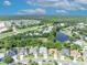 Peaceful neighborhood aerial showcasing lush greenery, a pond, and blue skies at 12618 Lakebrook Dr, Orlando, FL 32828