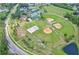 A birdseye view of a community recreation area featuring baseball and sandlot fields, along with tennis courts at 12618 Lakebrook Dr, Orlando, FL 32828