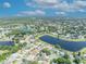 Expansive aerial view featuring a large pond surrounded by attractive homes and landscaping at 12618 Lakebrook Dr, Orlando, FL 32828