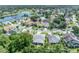 Real estate aerial showcasing the community's lovely homes amidst mature trees and a pond at 12618 Lakebrook Dr, Orlando, FL 32828