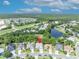 Charming neighborhood aerial shot with mature trees, a pond, and nearby amenities at 12618 Lakebrook Dr, Orlando, FL 32828