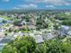Residential aerial view featuring a pond, tree-lined streets, and well-kept homes at 12618 Lakebrook Dr, Orlando, FL 32828
