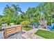 Lush backyard with well-manicured landscaping, a cozy fire pit, and comfortable outdoor seating at 12618 Lakebrook Dr, Orlando, FL 32828