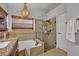 Bathroom with a glass shower and soaking tub at 12618 Lakebrook Dr, Orlando, FL 32828