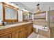 Bathroom features dual vanities, a soaking tub, and stylish fixtures at 12618 Lakebrook Dr, Orlando, FL 32828