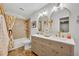 Elegant bathroom featuring double sinks, a modern vanity, and stylish lighting fixtures and shower at 12618 Lakebrook Dr, Orlando, FL 32828
