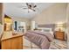 Cozy bedroom with natural light, a ceiling fan, and a decorative area rug at 12618 Lakebrook Dr, Orlando, FL 32828