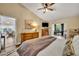 Comfortable bedroom showing an ensuite office and hardwood floors at 12618 Lakebrook Dr, Orlando, FL 32828