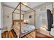 Cozy bedroom with a four-poster bed, wood floors, and soft lighting, creating a relaxing ambiance at 12618 Lakebrook Dr, Orlando, FL 32828