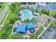 Overhead view of neighborhood pool, clubhouse, and playground, all beautifully landscaped with a lake nearby at 12618 Lakebrook Dr, Orlando, FL 32828