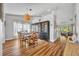 Elegant dining room featuring wood floors, natural light, and an open view into the living room at 12618 Lakebrook Dr, Orlando, FL 32828