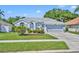 Charming single-Gathering home with a well-maintained lawn, gray paint, and a two-car garage at 12618 Lakebrook Dr, Orlando, FL 32828